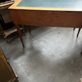 Louis XVI style marquetry desk. The top is decorated with green leather.