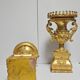 Rare pair of carved and gilded wooden vases, with a refined style inspired by the Empire.