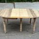 Round extendable dining table with flaps, stripped in raw oak, with 4 extensions.
