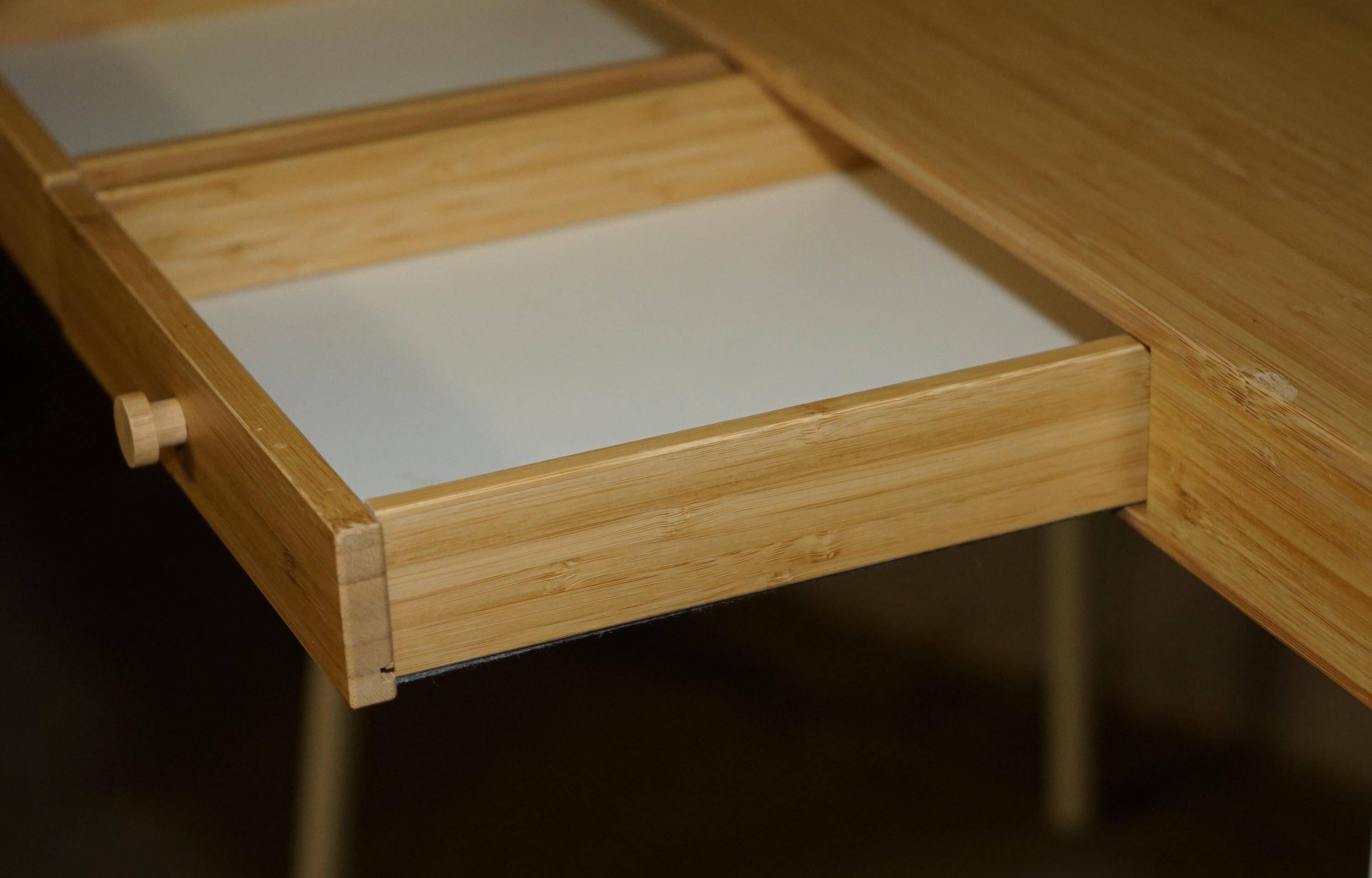 Small bamboo desk with three drawers.