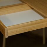 Small bamboo desk with three drawers.