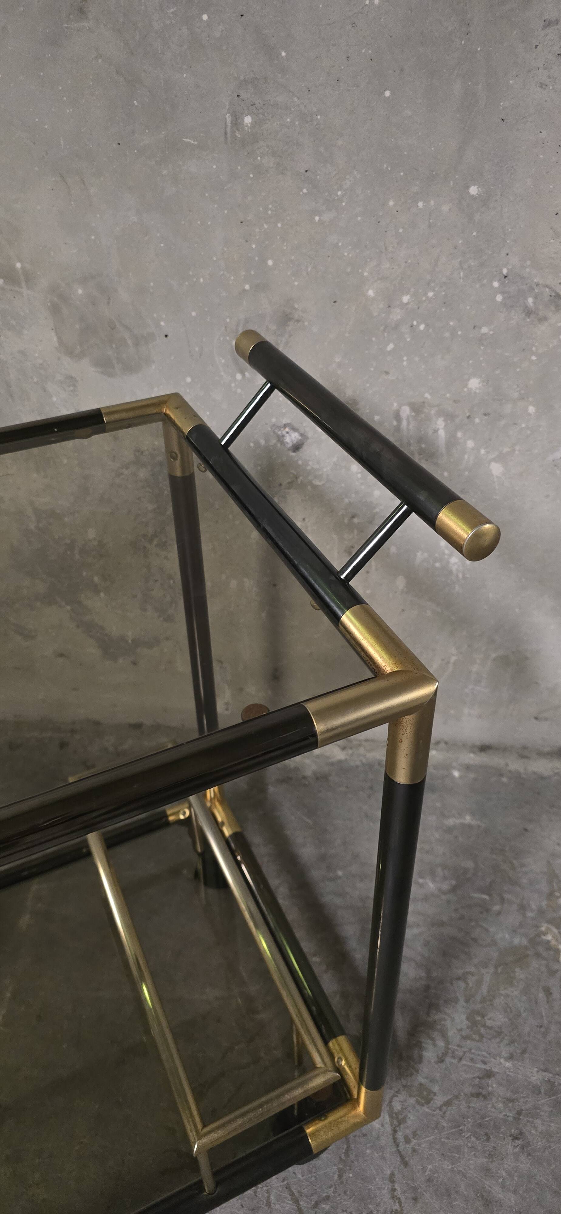 Black metal and brass rolling dessert trolley, smoked glass, 1970s.