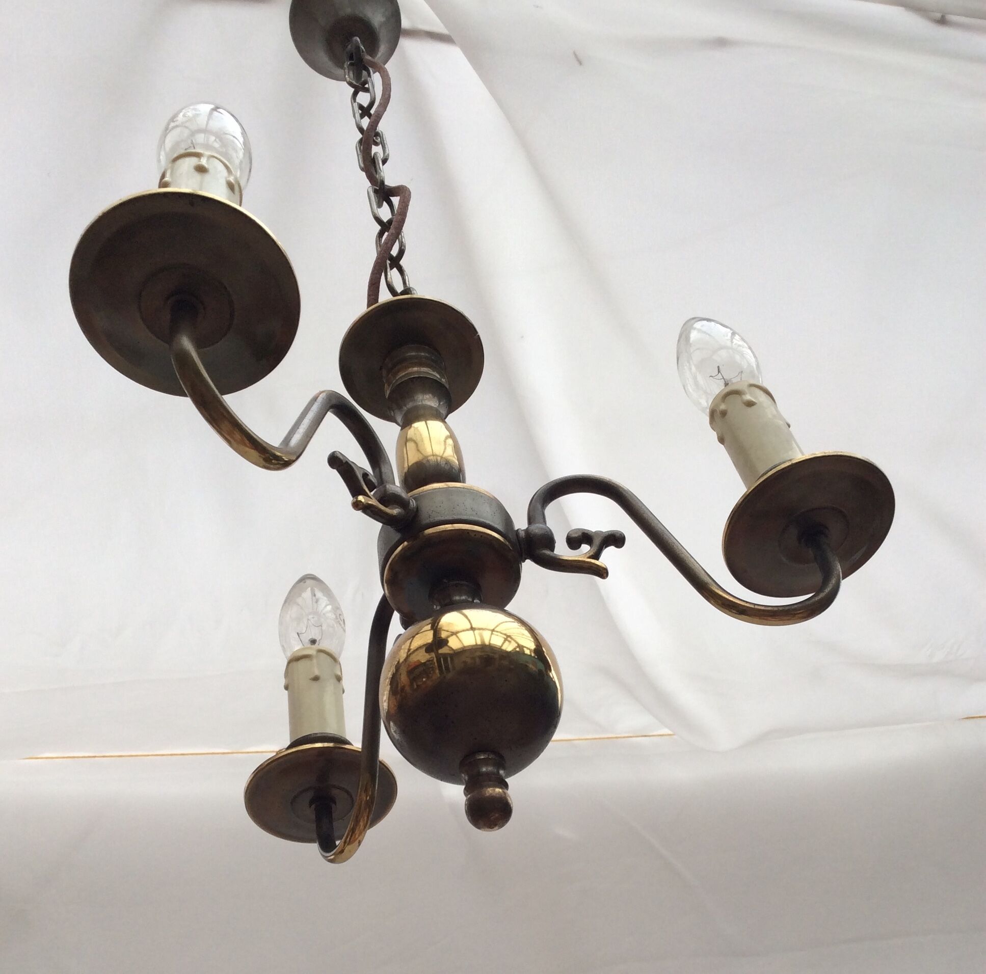 Metal chandelier repainted in copper color with 3 candle-shaped bulbs