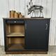 Small vintage black buffet with sliding doors.