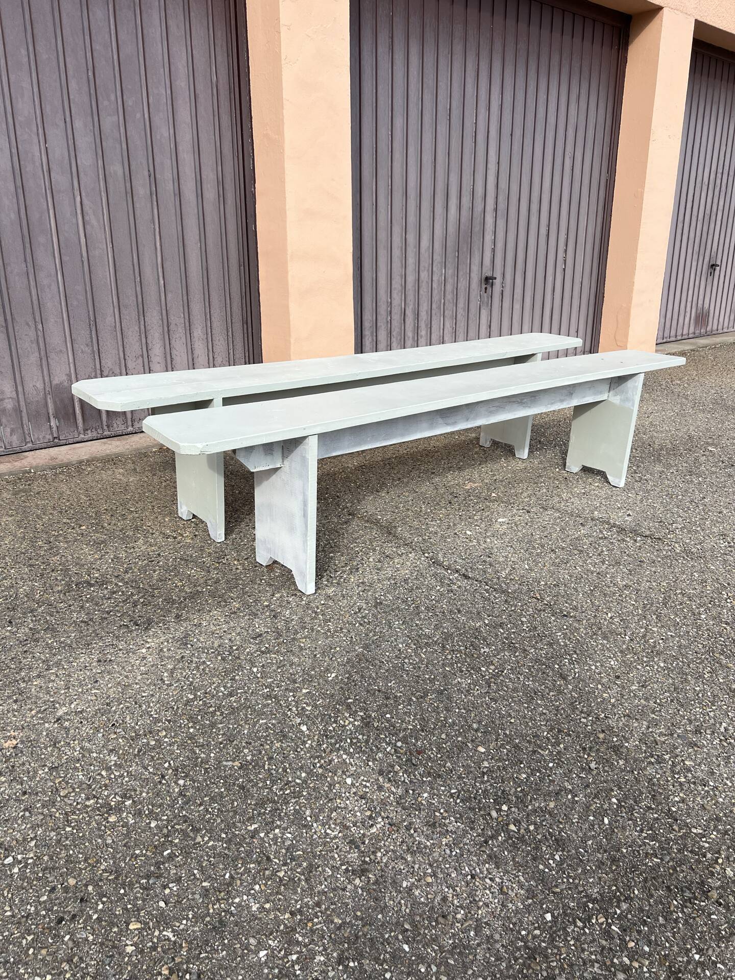 Pair of wooden benches painted white, French artisanal work.