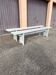 Pair of wooden benches painted white, French artisanal work.