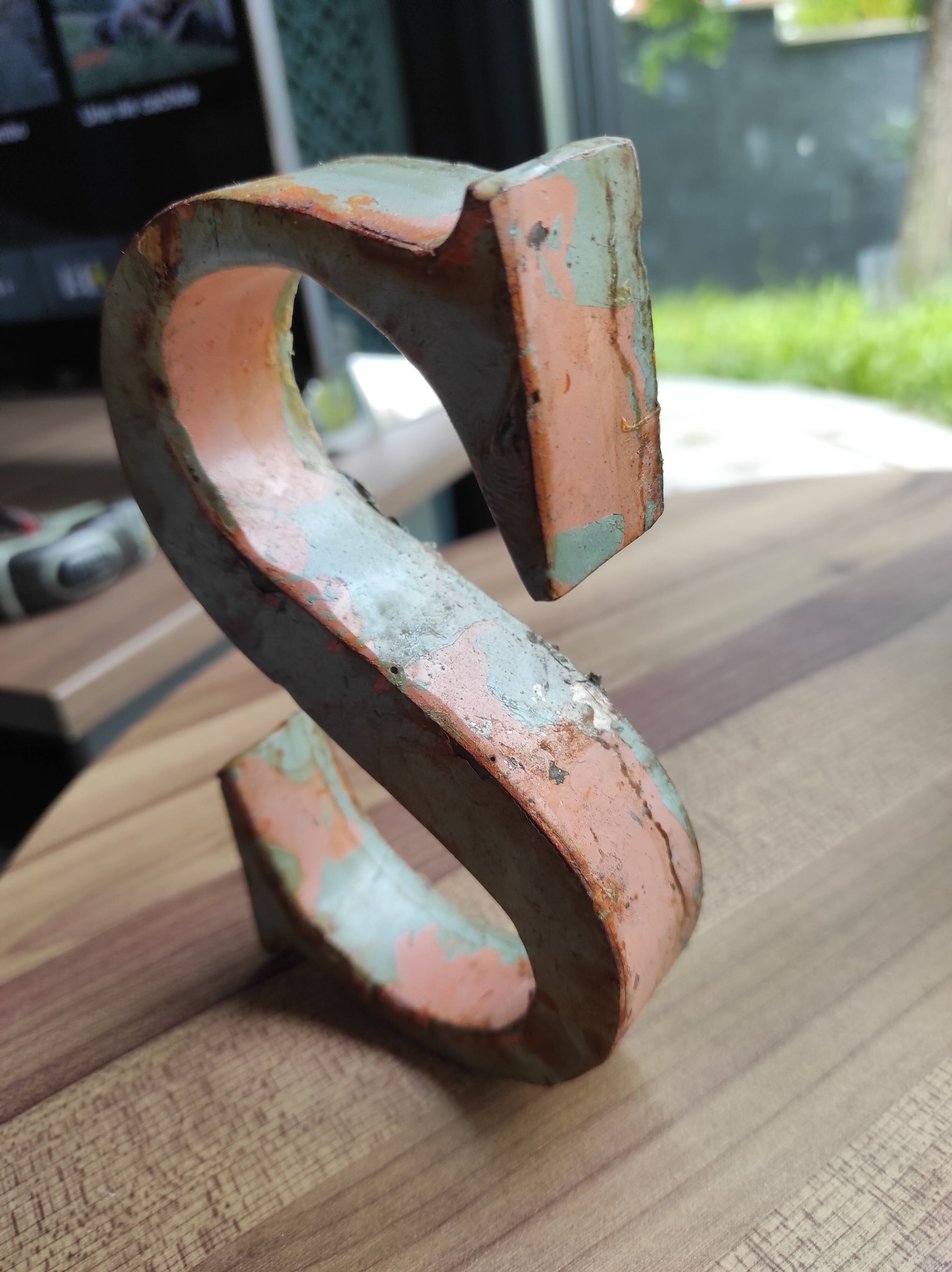 Old sign letter "S" in patinated metal