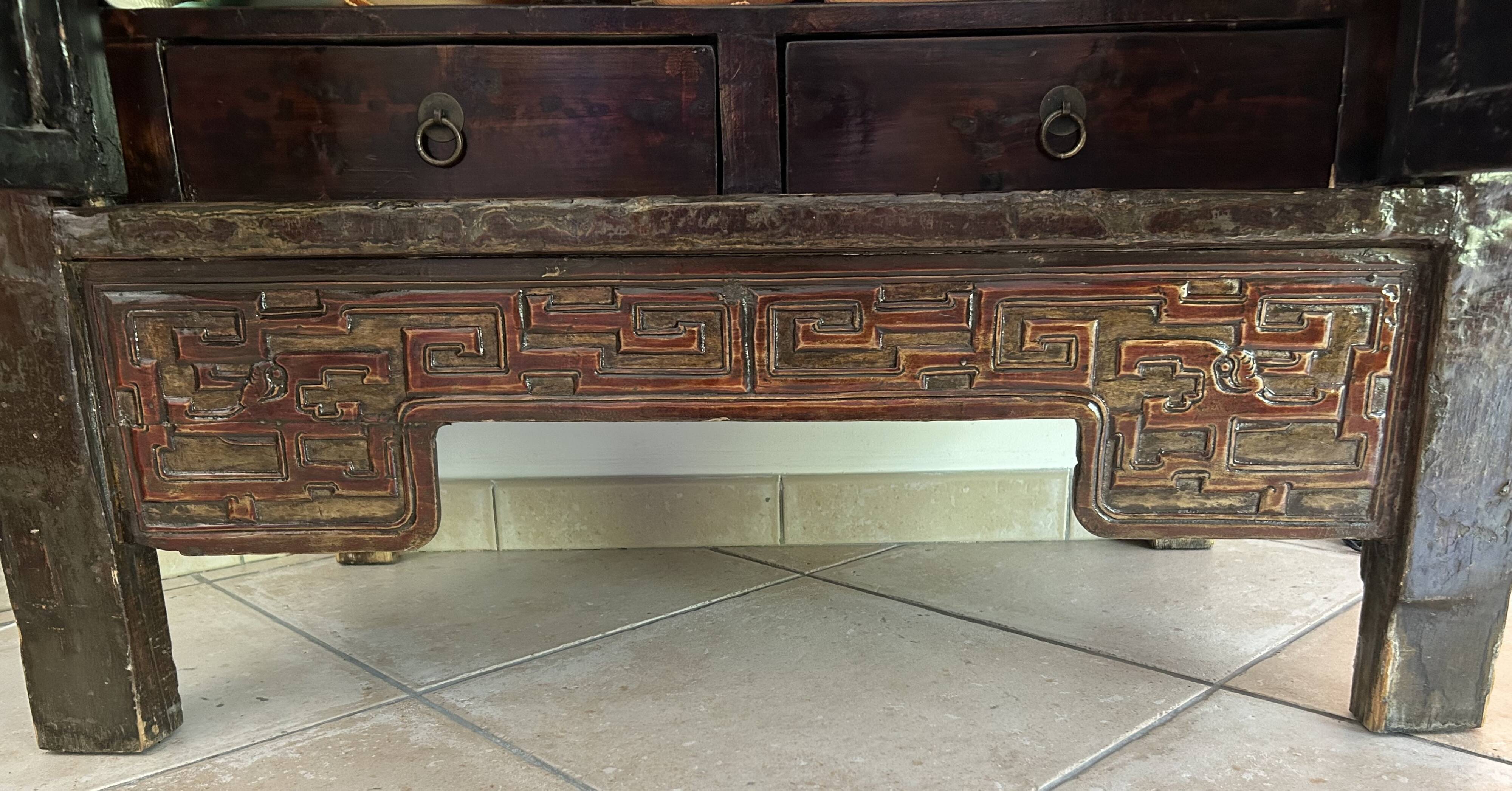 Antique Chinese wardrobe in carved elm.