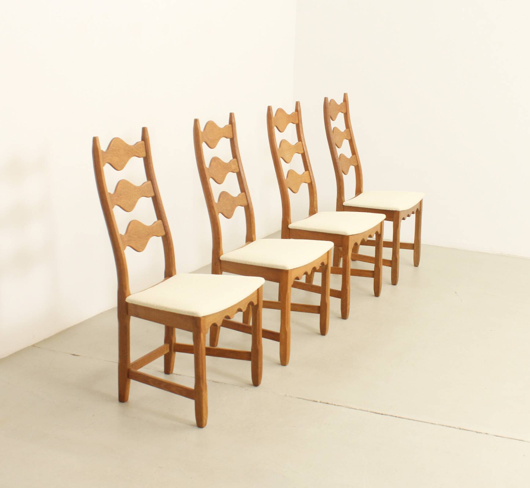 Four oak dining chairs by Henning Kjaernulf.