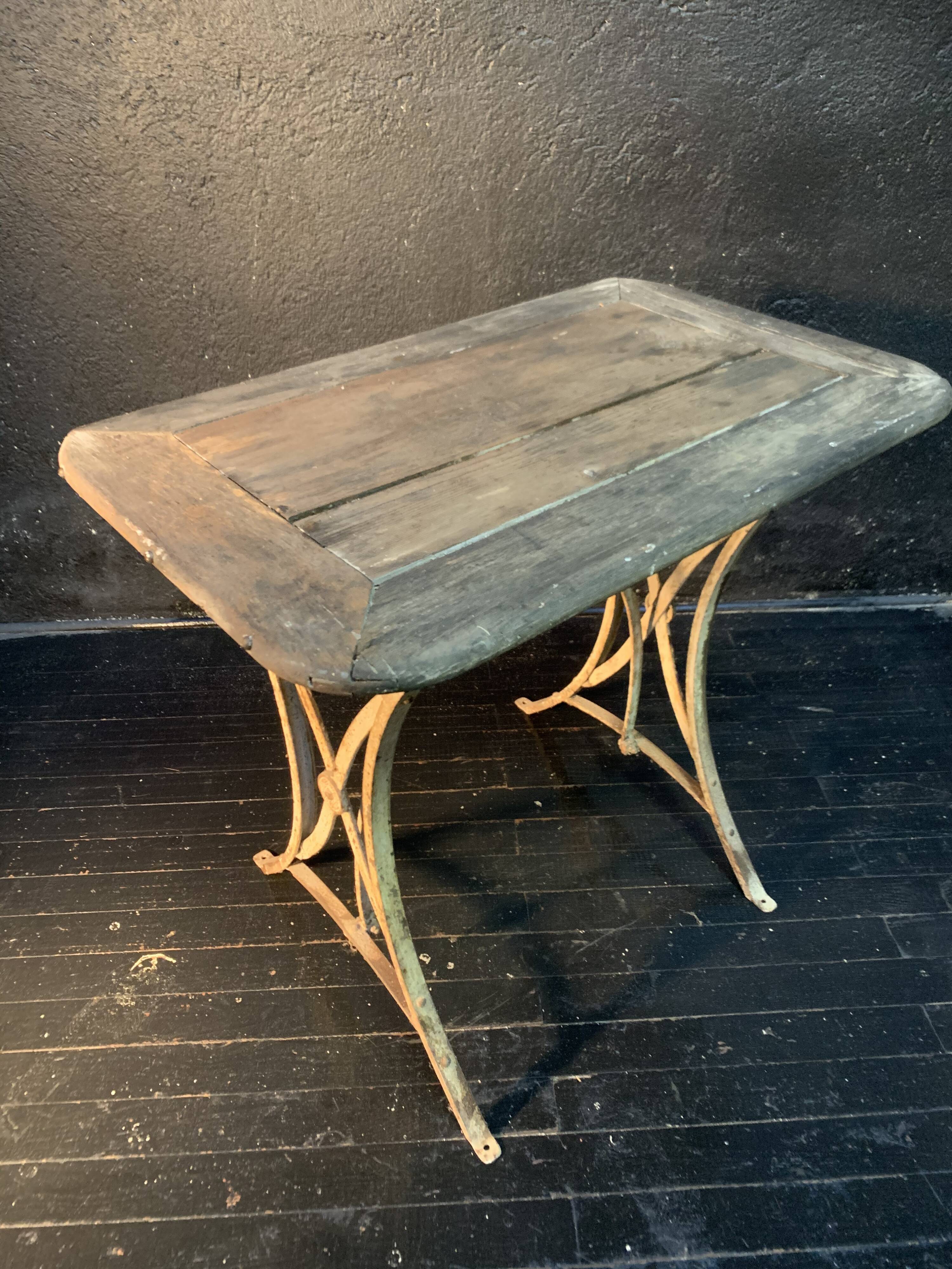 Ancient wrought iron and wood garden table