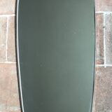 Vintage 1960 free-form mirror known as a retro mirror with a gold and black metal trim.