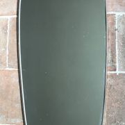 Vintage 1960 free-form mirror known as a retro mirror with a gold and black metal trim.