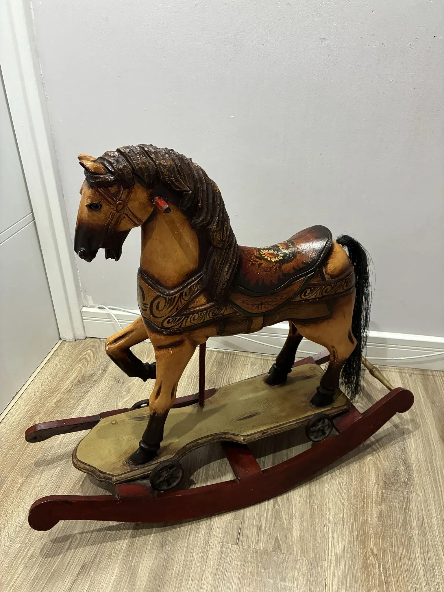 Antique hand-carved rocking horse on wheels, early 20th century