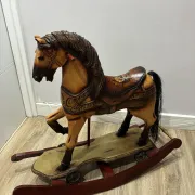 Antique hand-carved rocking horse on wheels, early 20th century