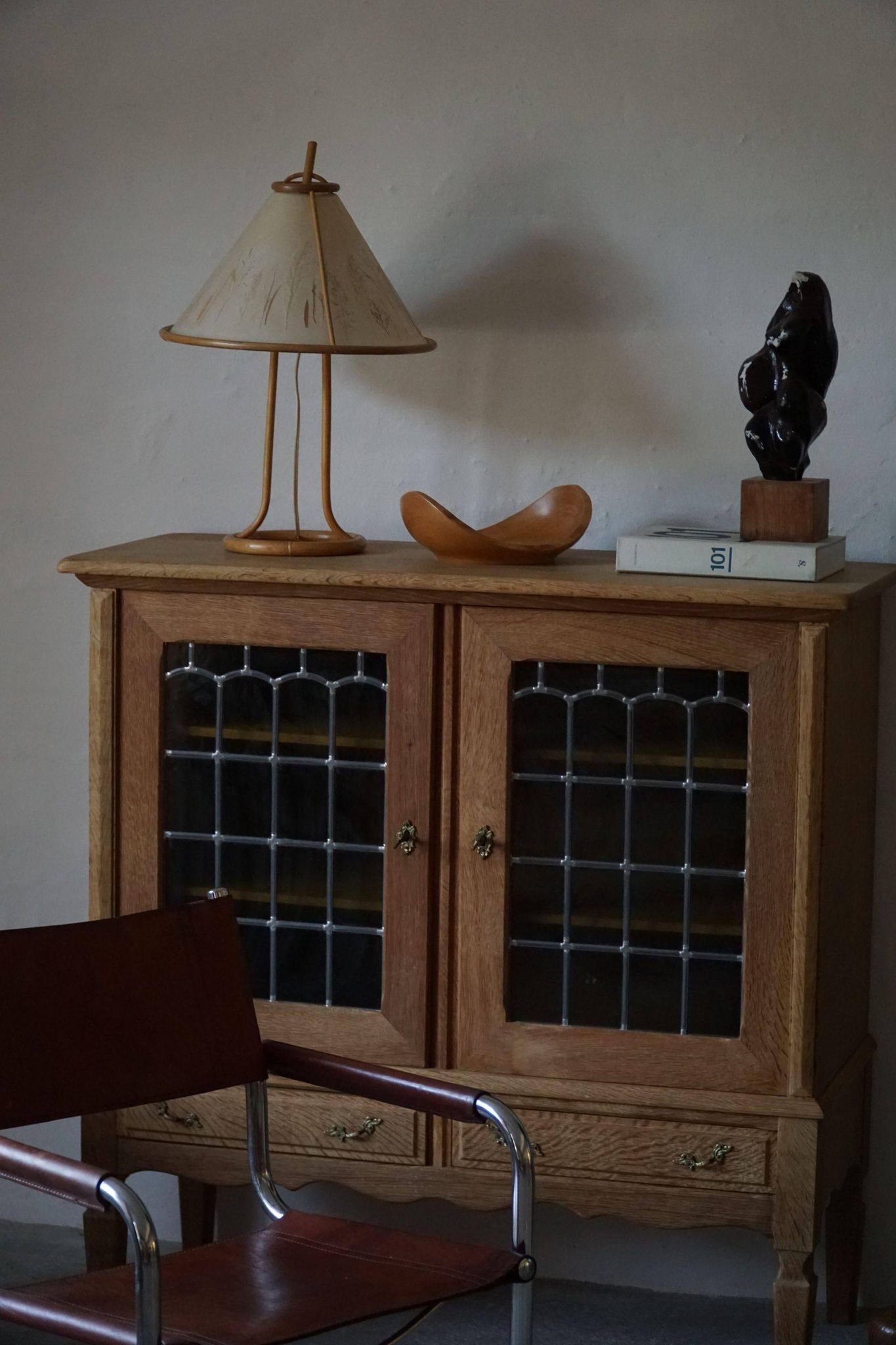 20th-century mid-century solid oak sideboard with glass front, by a Danish cabinetmaker.
