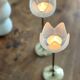 Pair of tulip-shaped candle holders in frosted glass and brass.