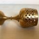 Lattice brass catchall and candlestick.