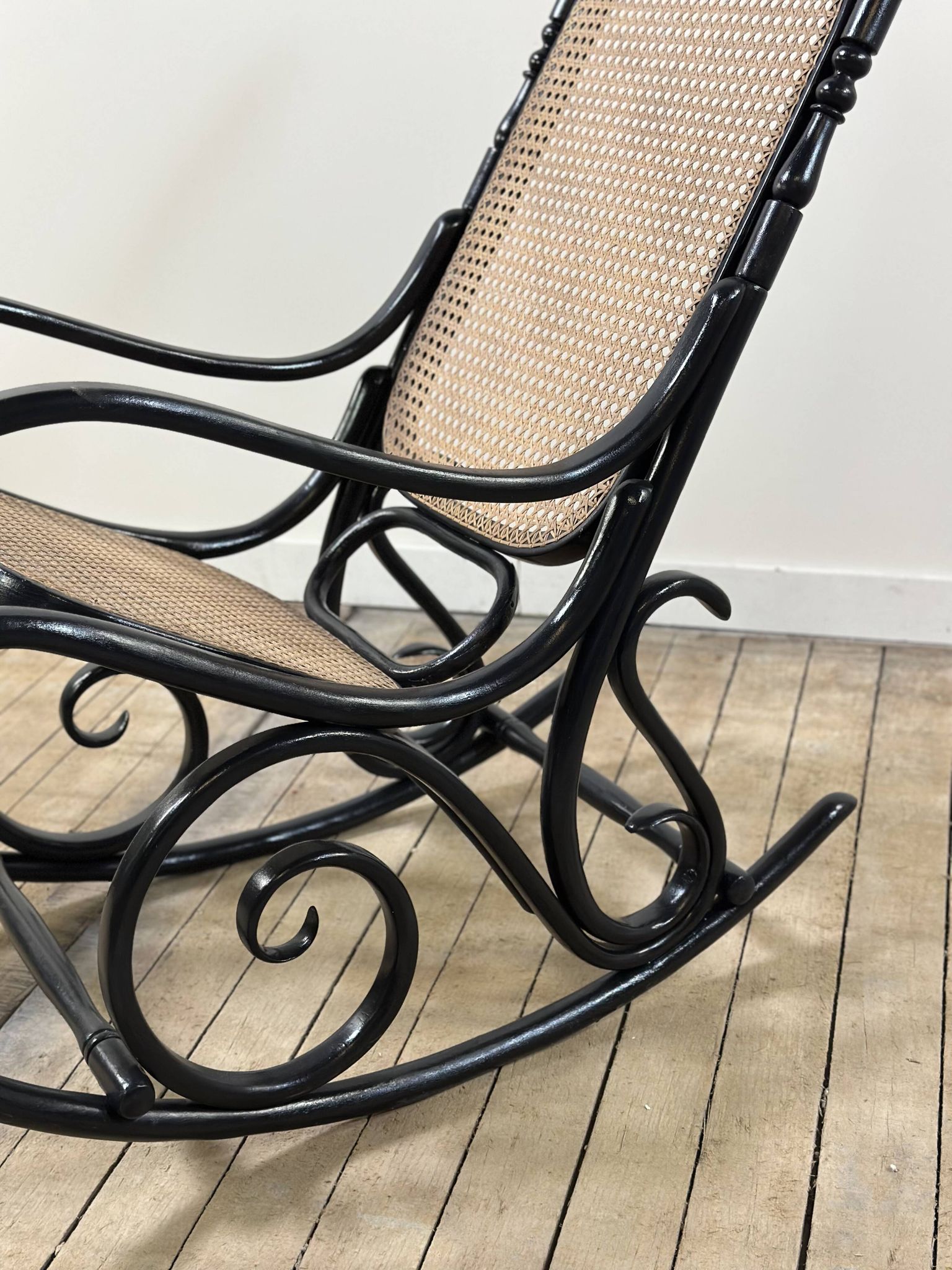 Rocking chair in blackened curved wood and cane, 1900s