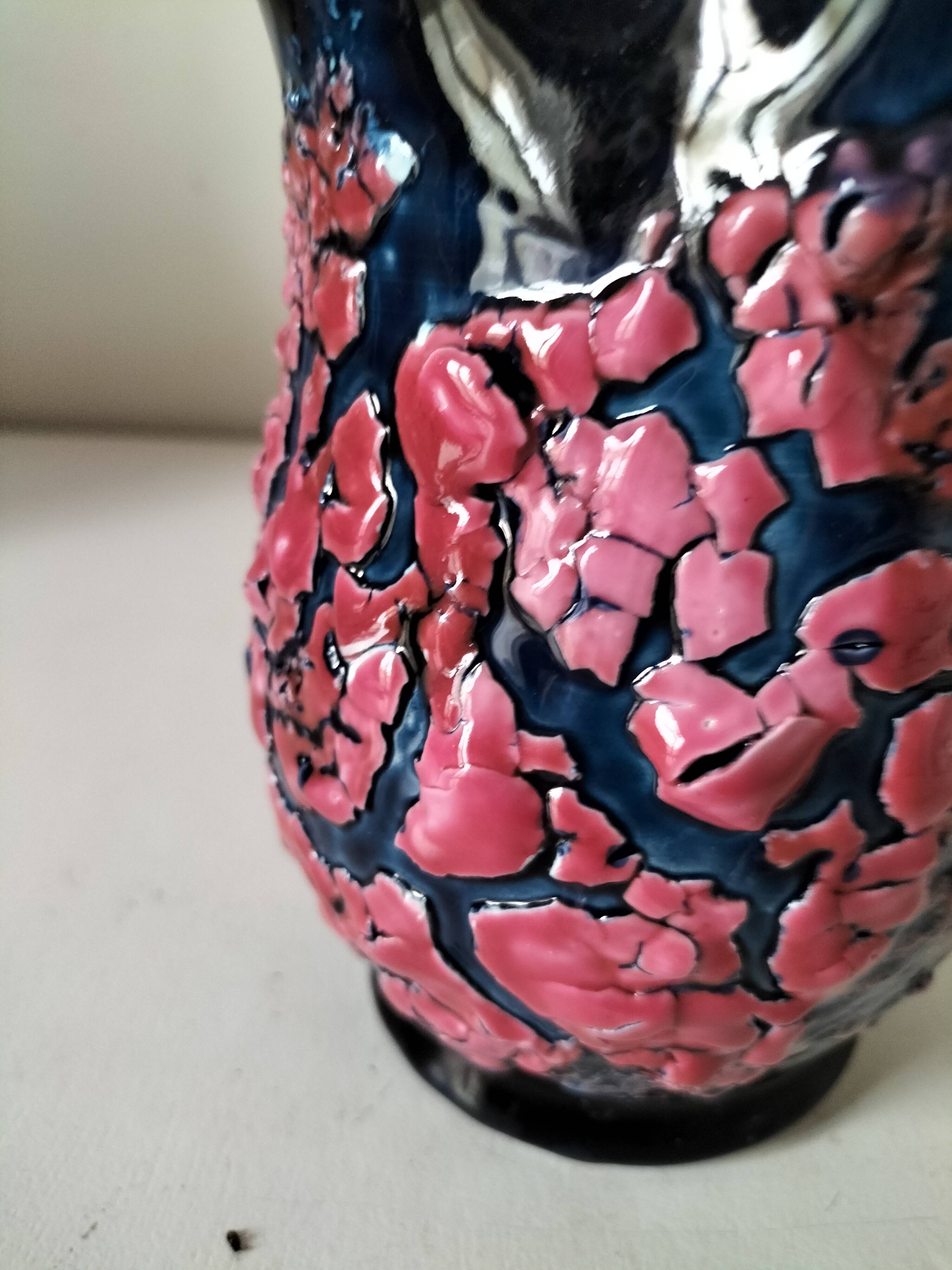 Vintage pitcher in midnight blue glazed ceramic with bright pink relief