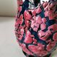 Vintage pitcher in midnight blue glazed ceramic with bright pink relief