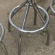 Set of 5 vintage swivel bar stools in blue, red, orange, and yellow.
