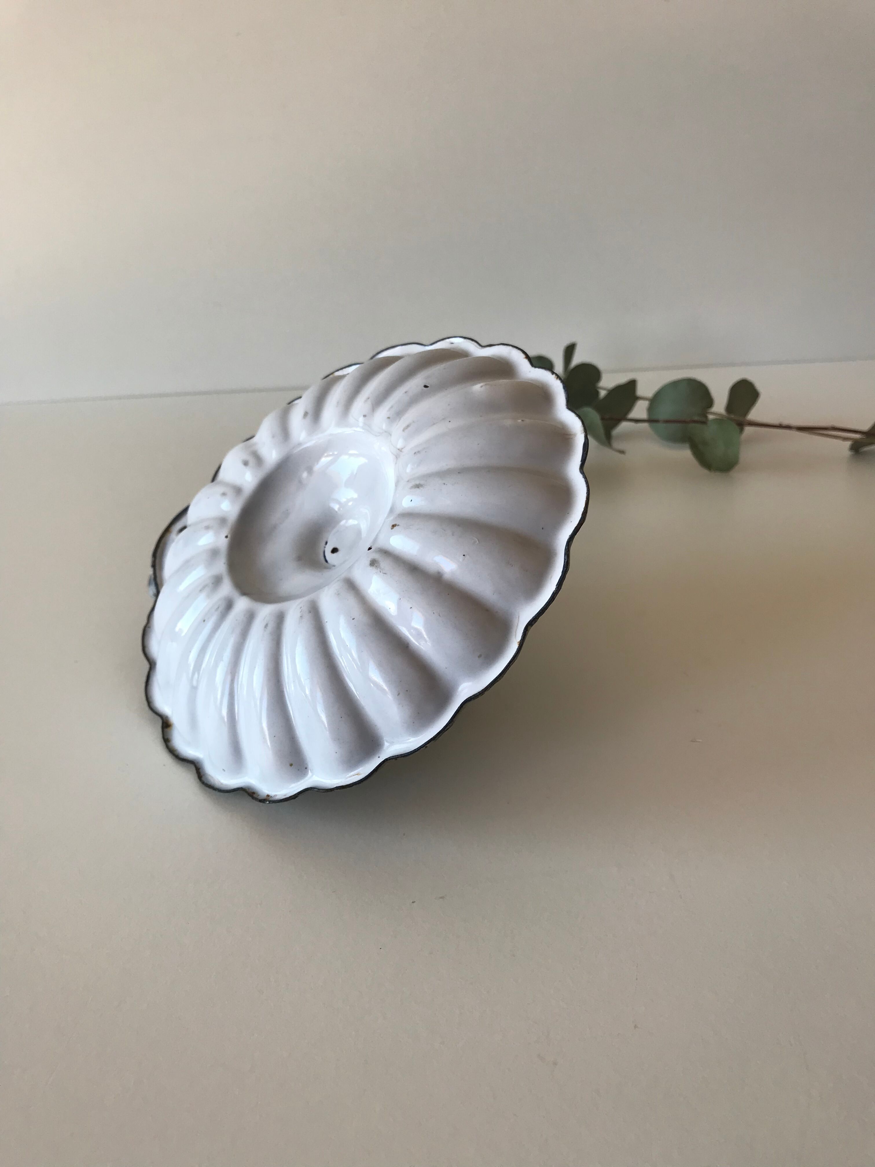 Candlestick in white enameled metal