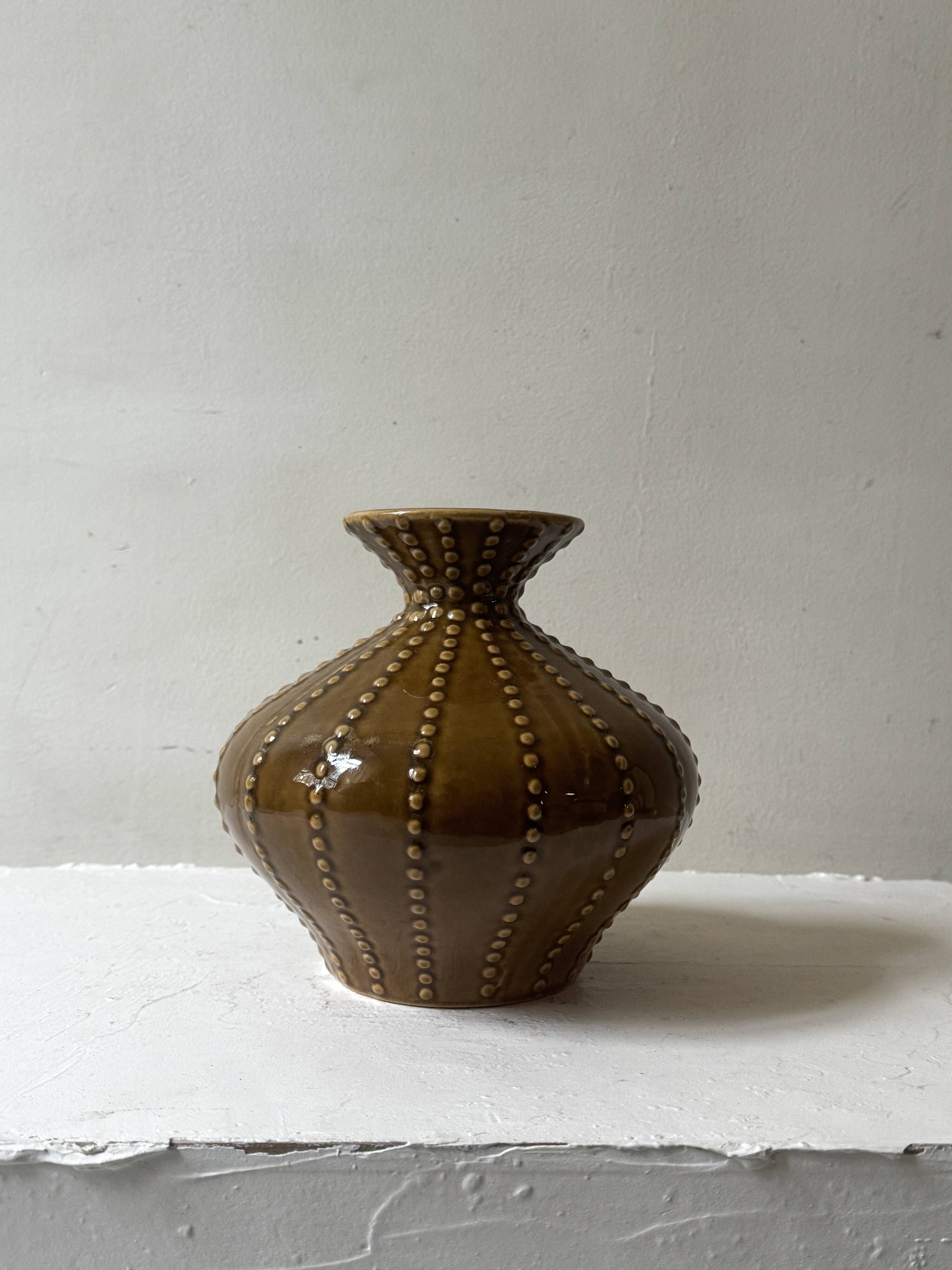 Pyriform vase in glazed ochre ceramic and beads.