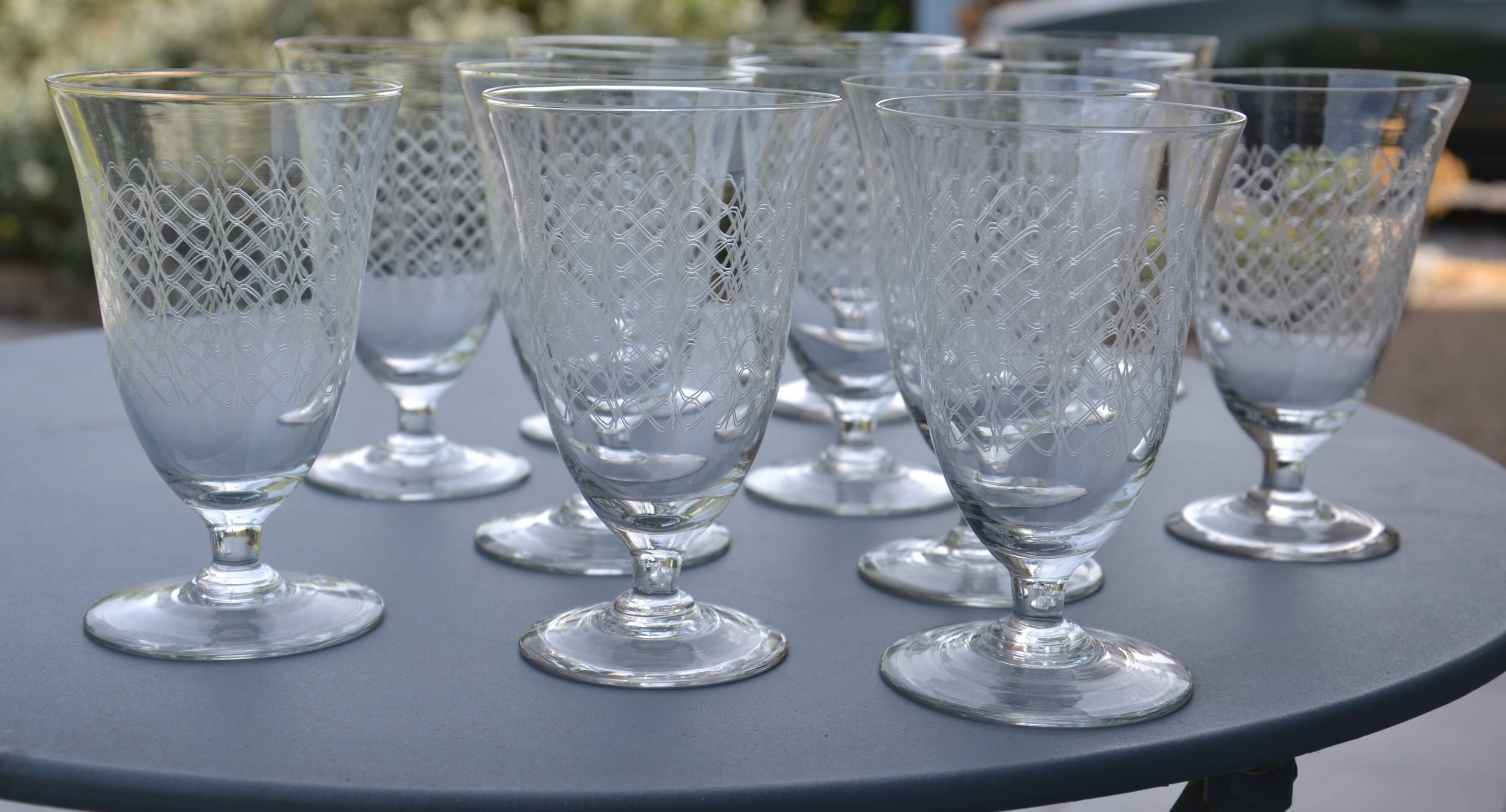 12 wine/water glasses engraved with Art Nouveau garland.