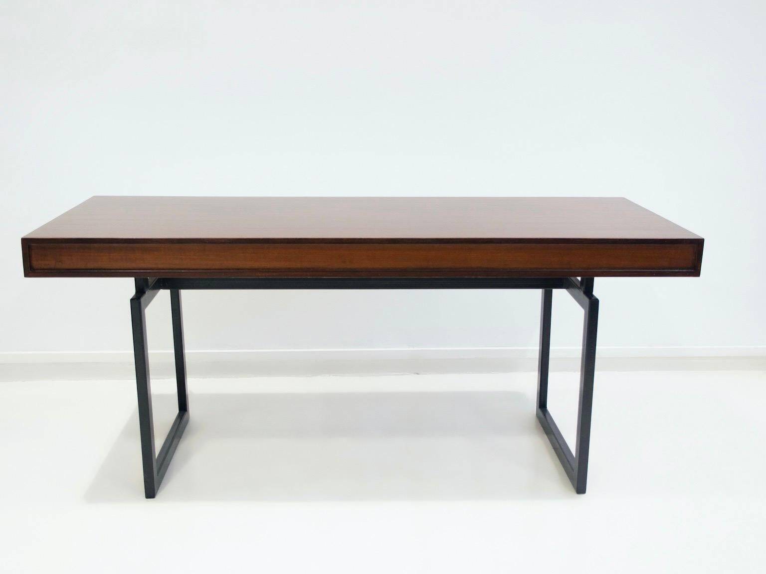 Wooden desk with drawers and black lacquered legs.