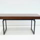Wooden desk with drawers and black lacquered legs.