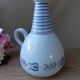 Vintage blue ceramic jug with hand-painted floral decoration.