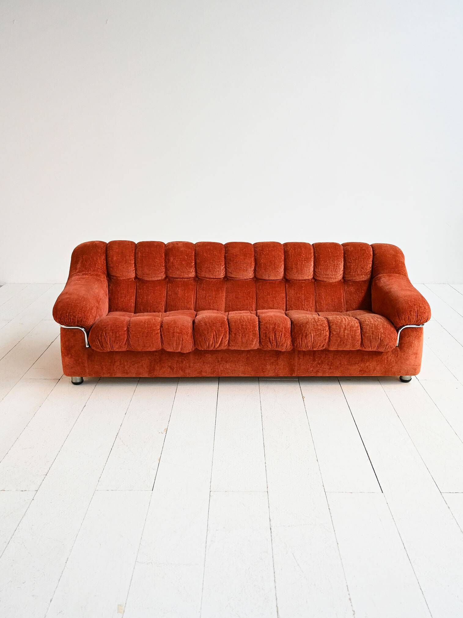 Vintage rust velvet sofa from the 1970s with metal details.