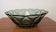 Vintage green smoked glass coupe with geometric decoration.