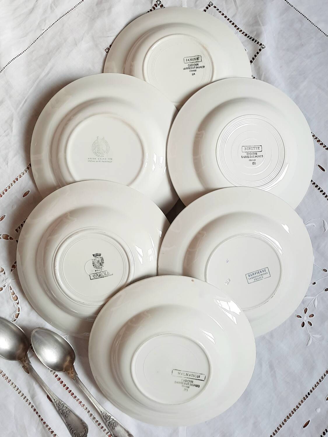 Mismatched old soup plates accompanied by a soup tureen