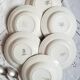 Mismatched old soup plates accompanied by a soup tureen