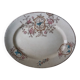 Large antique plate stamped with a fauna and flora pattern.