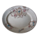 Large antique plate stamped with a fauna and flora pattern.