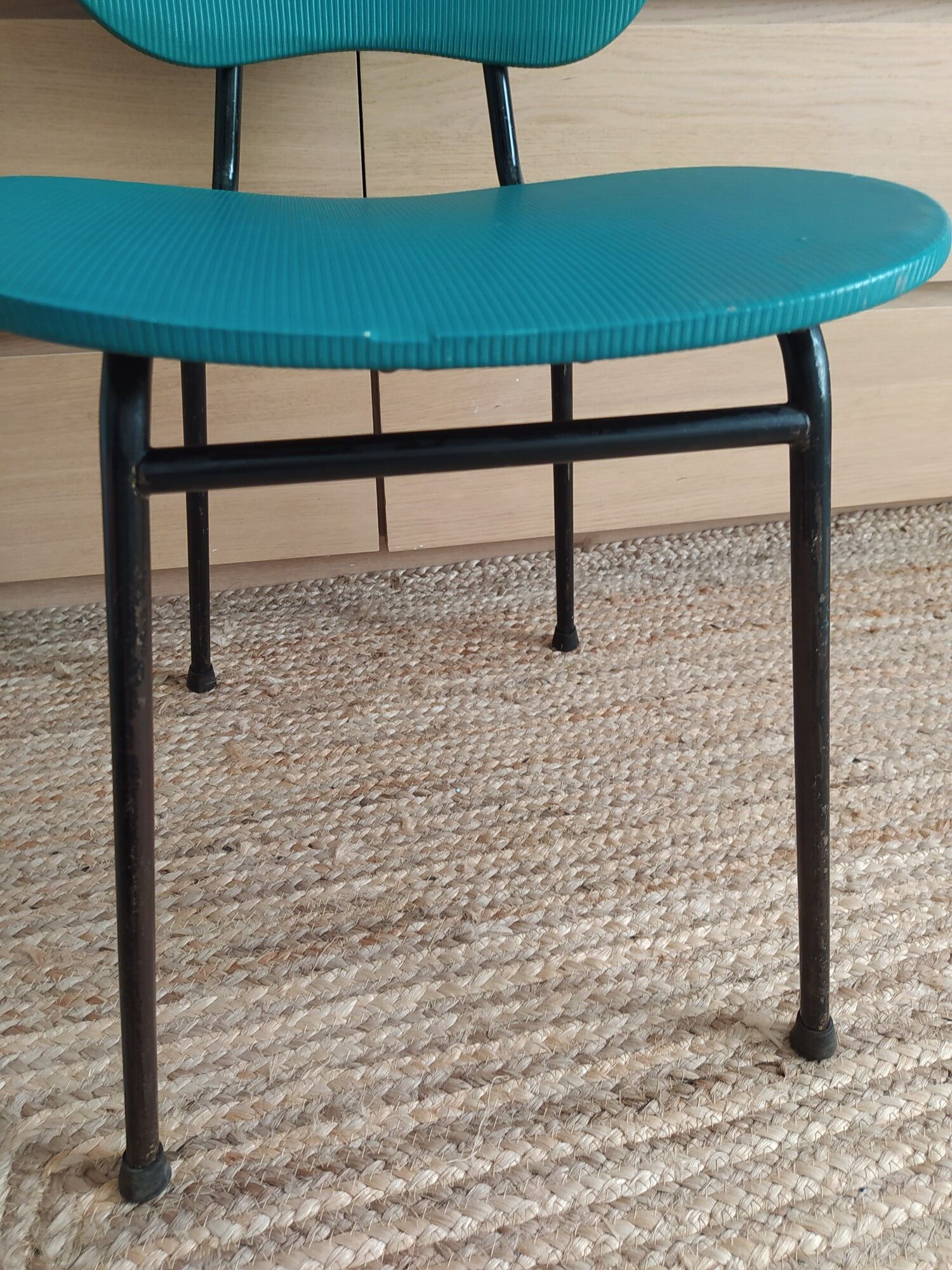 Vintage chair in turquoise green vinyl with black metal legs