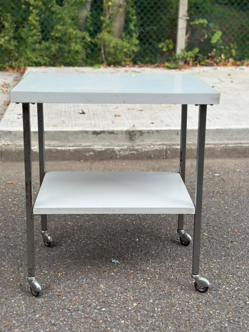 Rolling dessert trolley with 2 white formica shelves and steel, 1980.