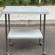 Rolling dessert trolley with 2 white formica shelves and steel, 1980.