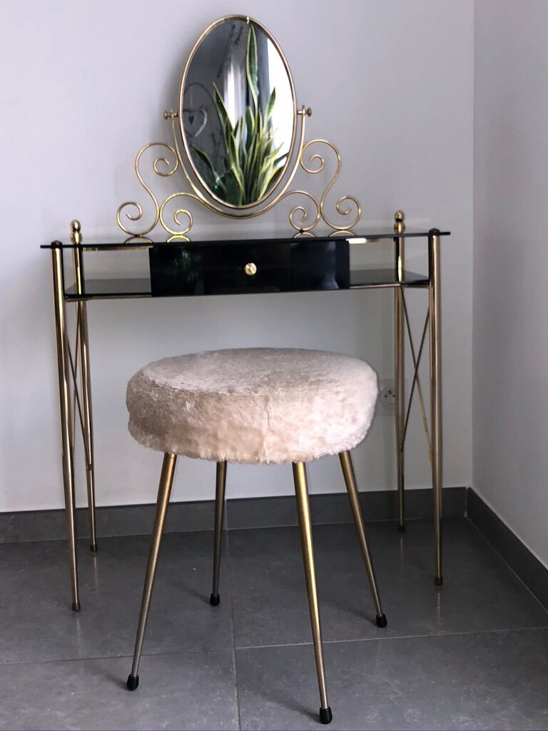 Brass hairdresser, glass and black plastic with its fluffy stool.