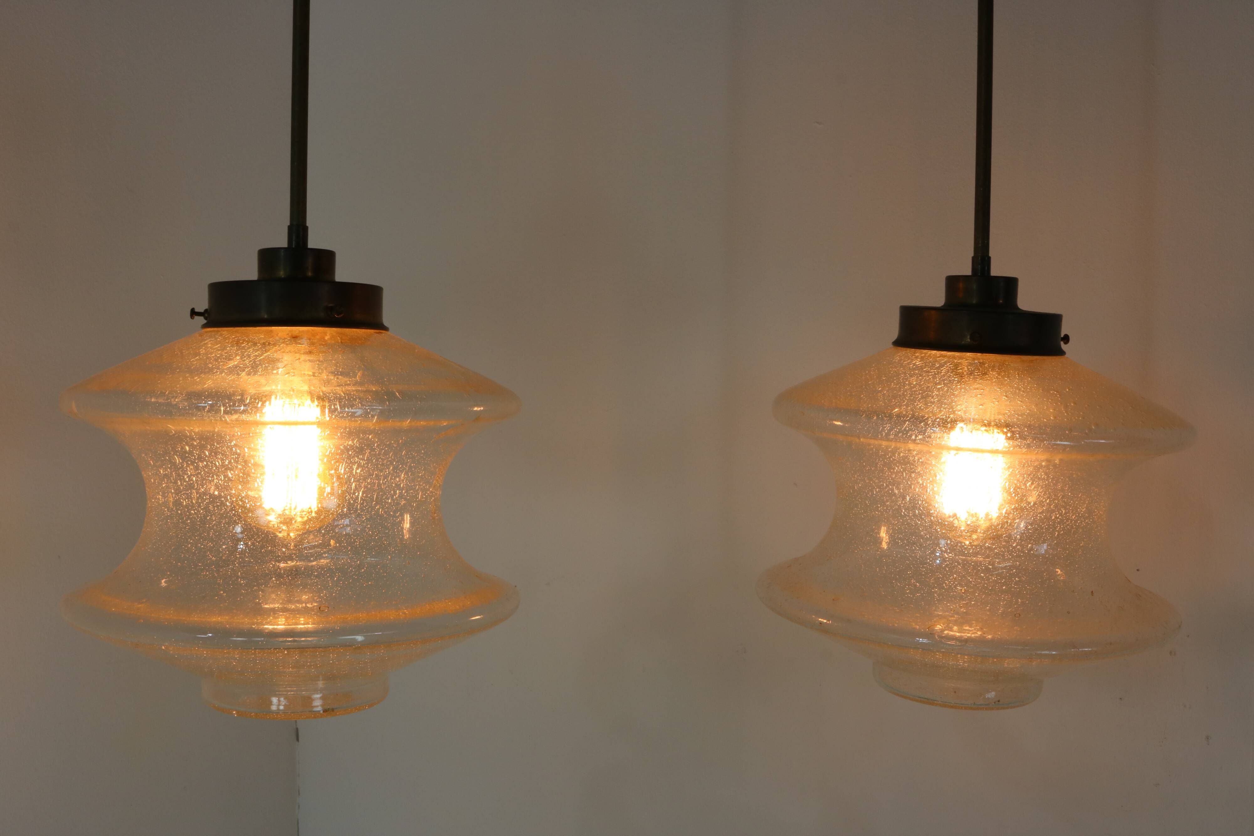 Set of two glass pendant lighting designed by Raak Holland