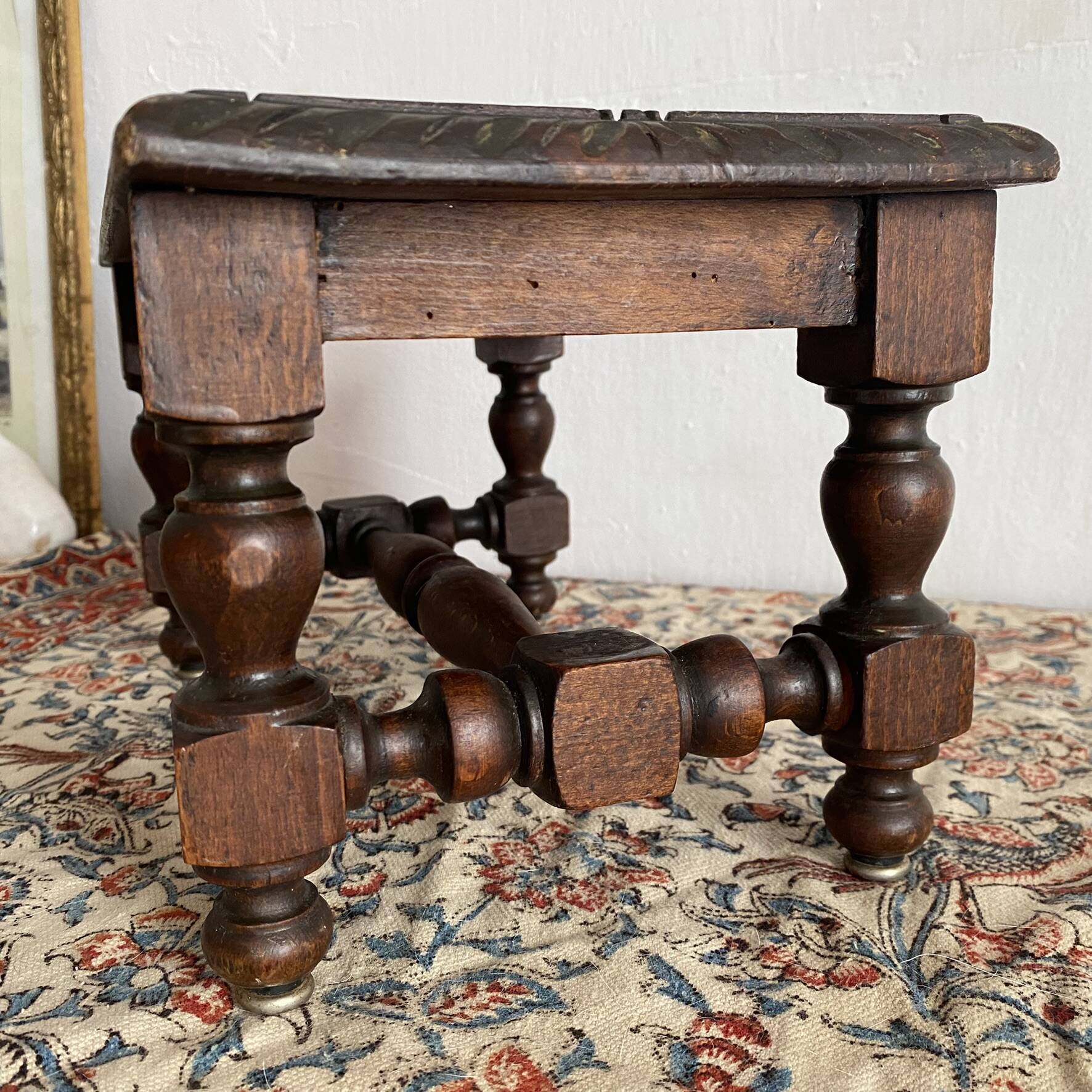 Low stool in carved wood
