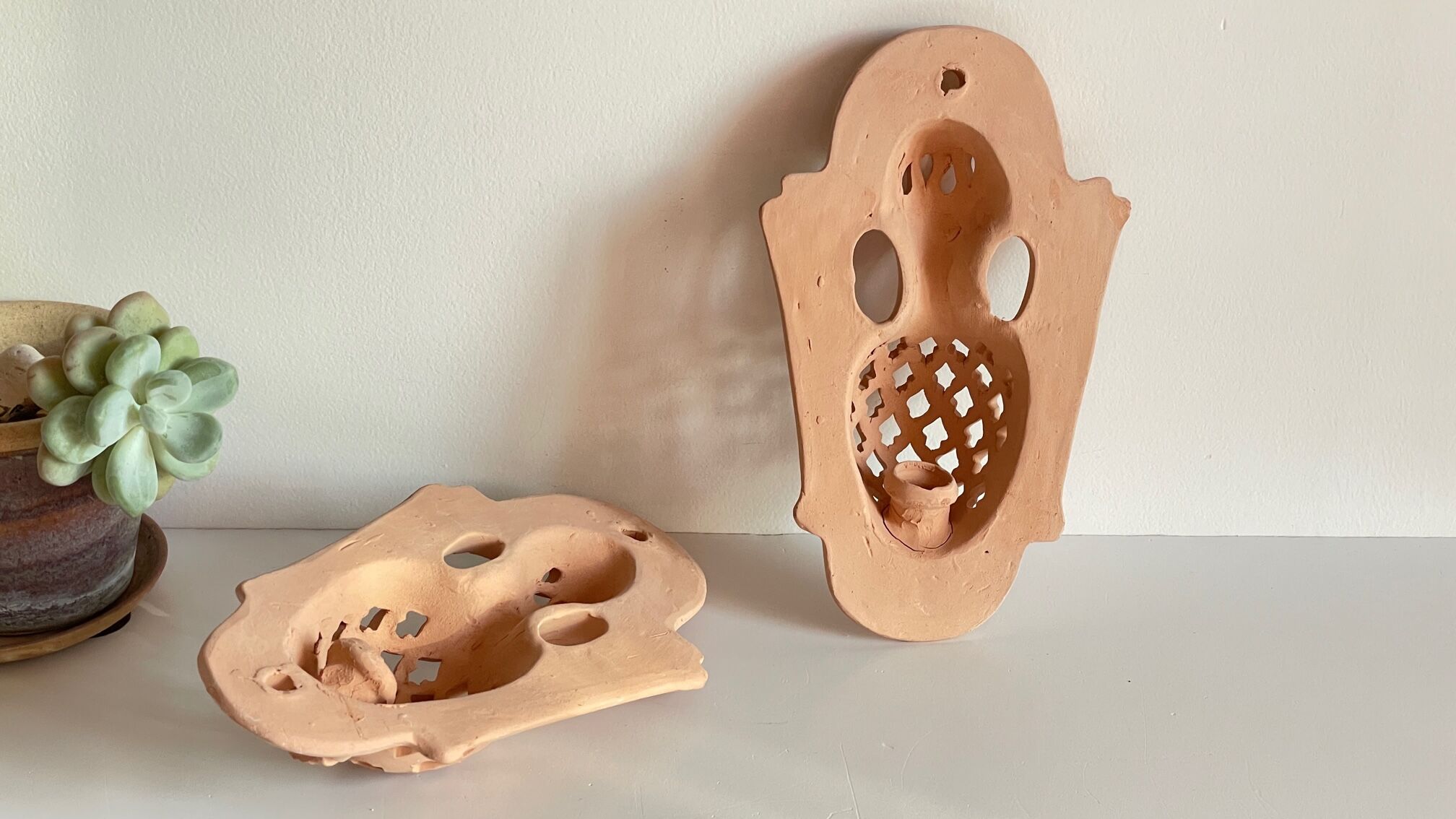Pair of terracotta wall candle holders