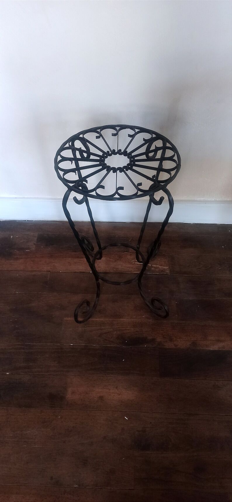 Black wrought iron support for plants