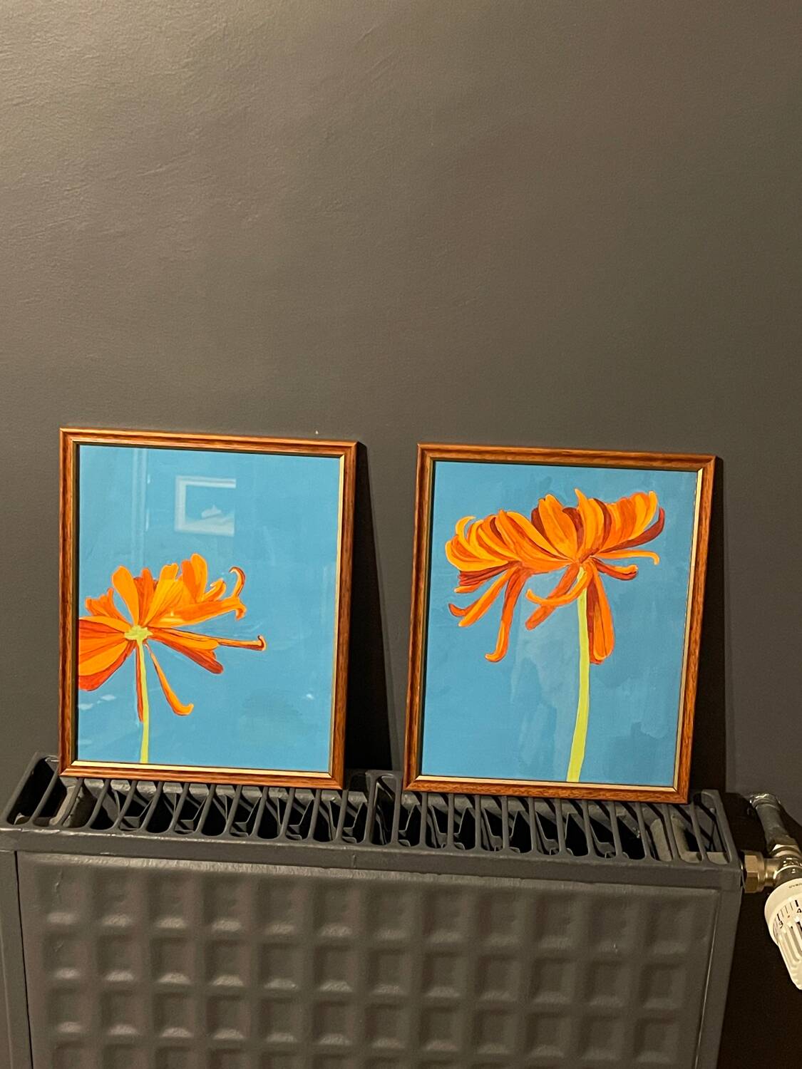 2 paintings of orange dahlias in antique wooden frames