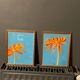 2 paintings of orange dahlias in antique wooden frames