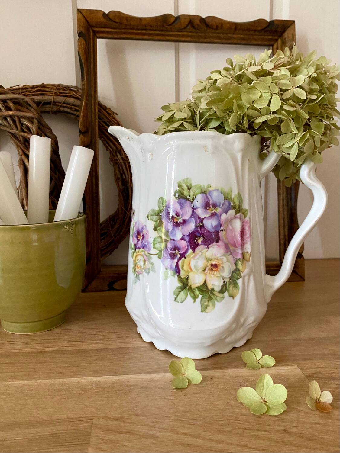 Old ceramic pitcher decorated with flowers