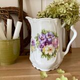 Old ceramic pitcher decorated with flowers