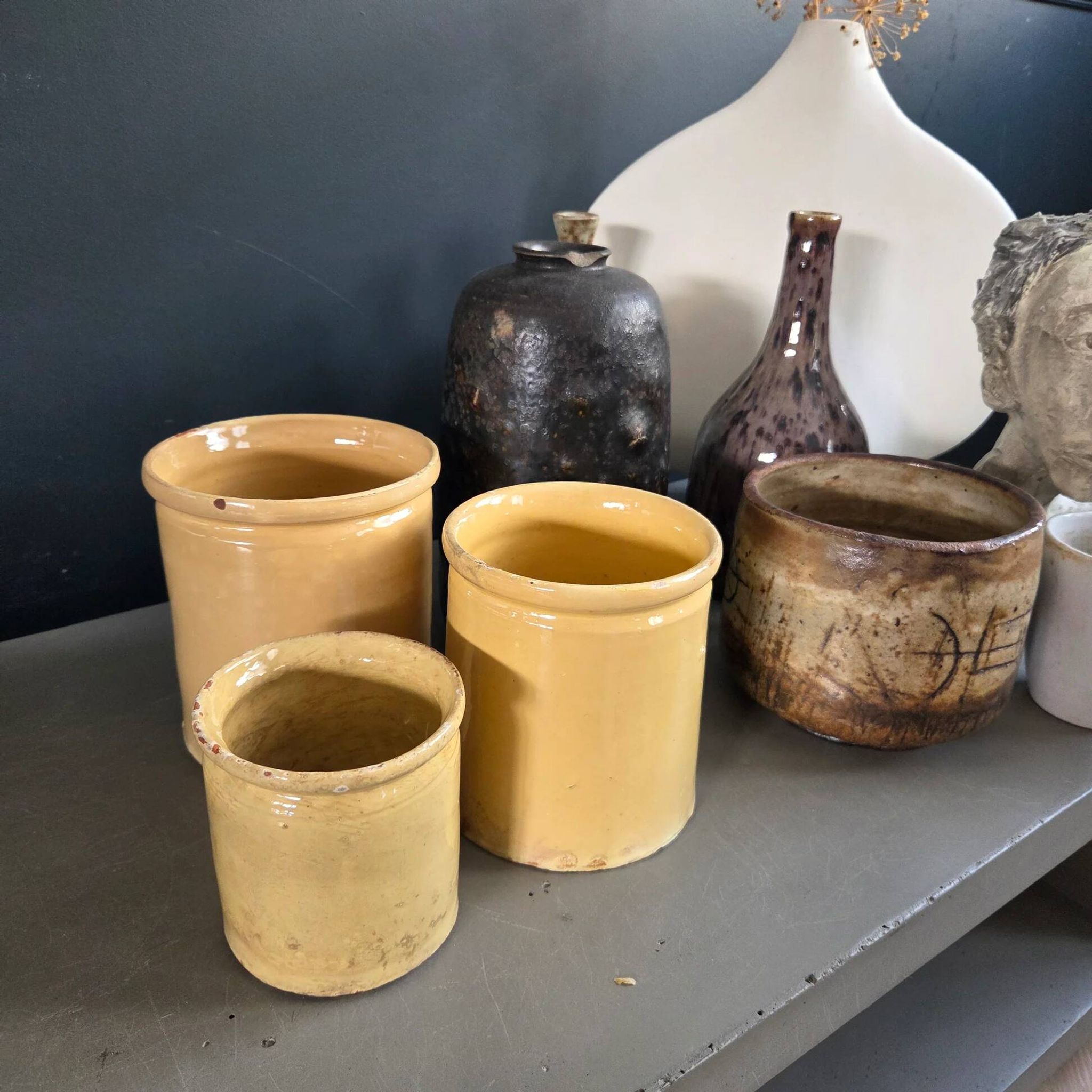 Trio of ancient pots in yellow glazed terracotta.